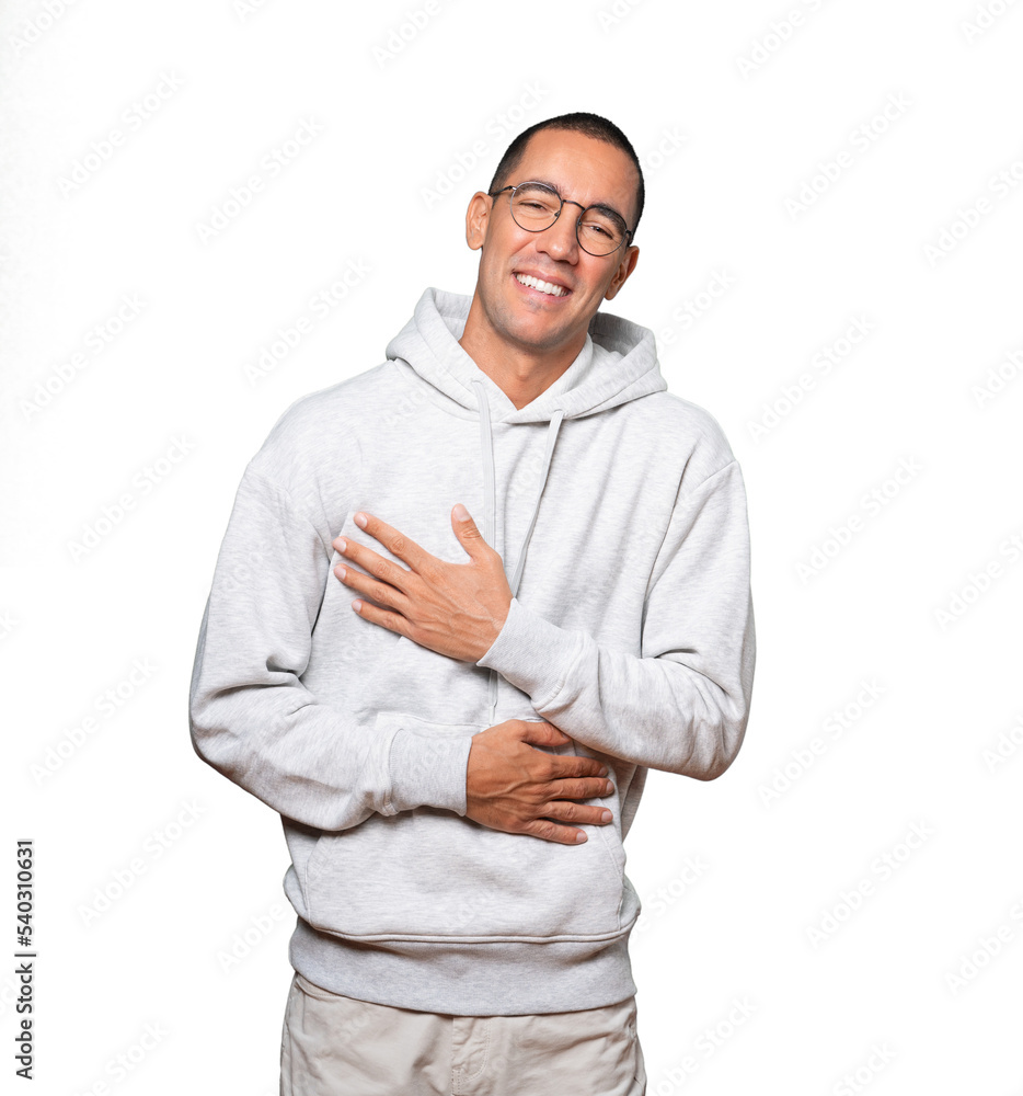 Happy young man laughing against background Happy young man laughing against background