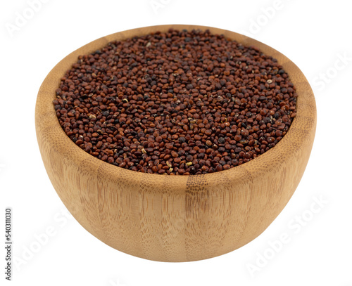 Side view of a wood bowl filled with red quinoa isolated on a white background.