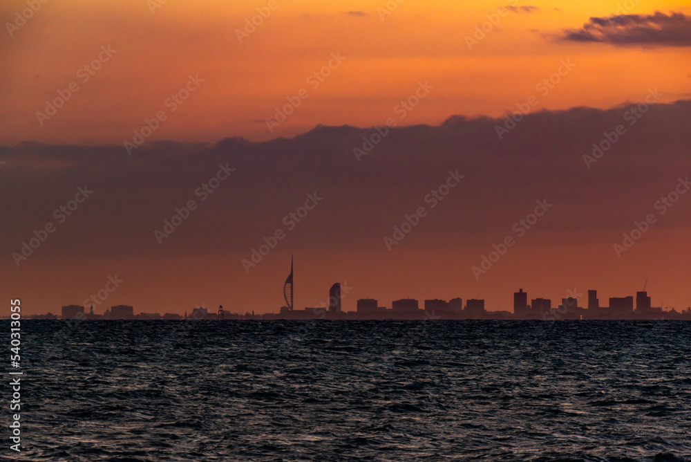 Spinnaker tower Portsmouth, orange sunset over the city from Selsey UK