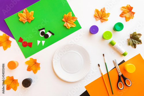 Cuts of paper for Halloween. Hand cut paper. Colors, scissors and glue. On a light background. Top view. Flat lay. DIY. Step by step.
