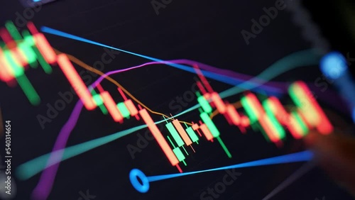 man trading stocks and is analyzing the financial markets on his tablet , is a technology in the digital world