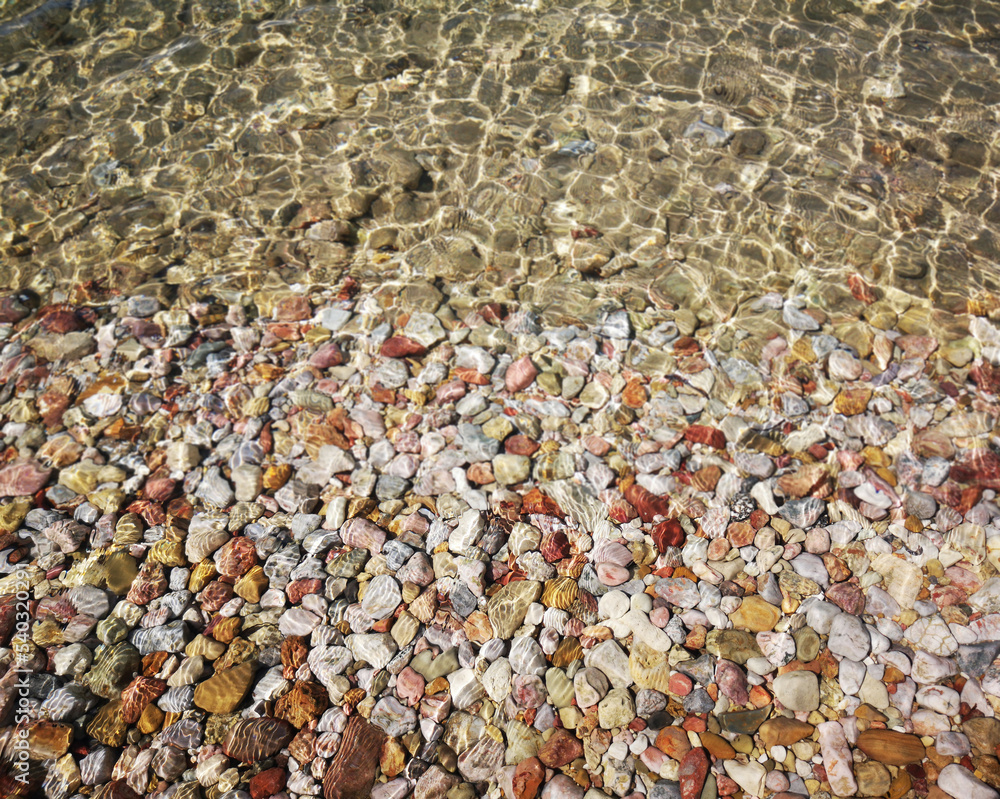 Pebbles and sea water, beach view Pebbles and sea water, beach view