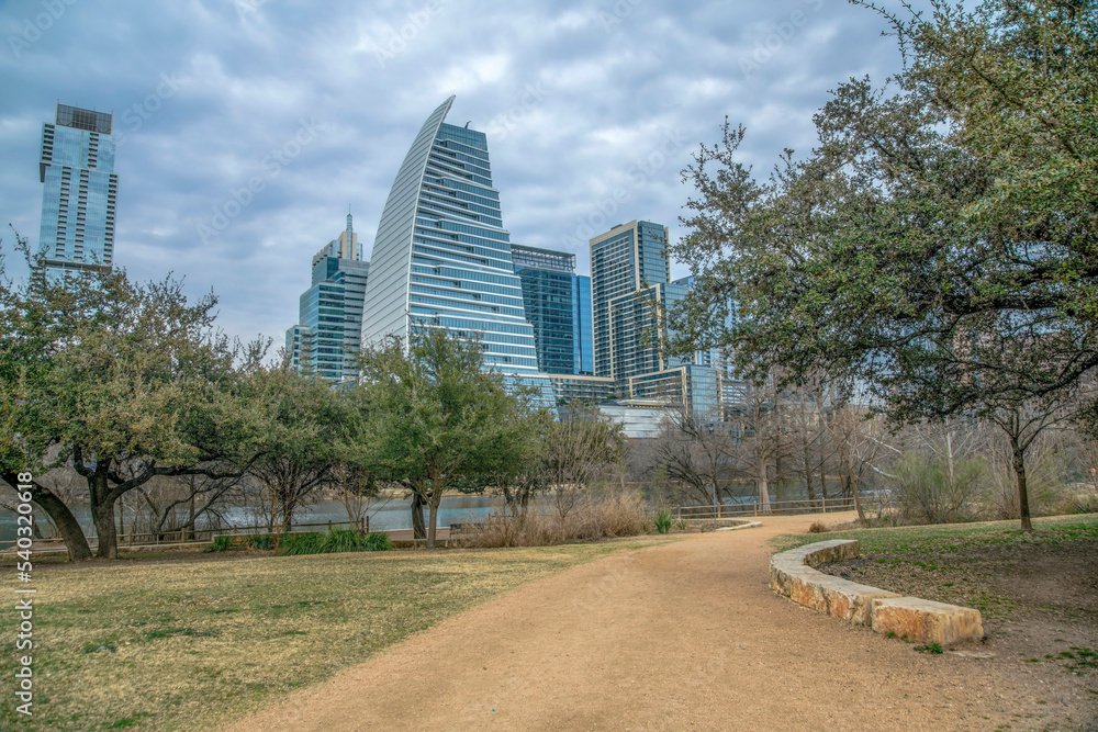 Auditorium Shores Park, Austin, Texas- Pathway with a citscape view against the clouds Auditorium Shores Park, Austin, Texas- Pathway with a citscape view against the clouds