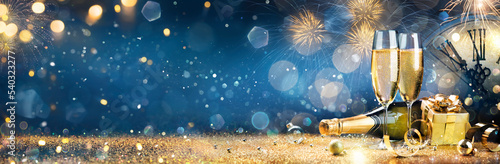 New Year Celebration - Toast With Champagne And Fireworks - Defocused Bokeh Lights And Glittering Effect On Background 