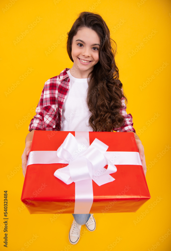 Teenager child with gift box. Present for holidays. Happy birthday, Valentines day, New Year or Christmas. Kid hold present box. Happy teenage girl, positive and smiling emotions.