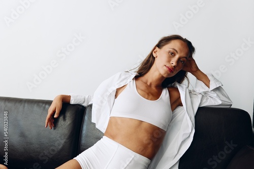 Tableau sur toile Woman with tanned skin fashion naturally sexy poses in her home clothes in the s