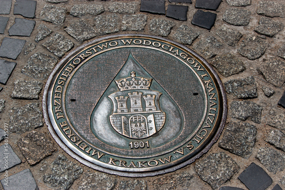 Decorative manhole cover with coat of arms in Jasna Gora, Czestochowa, Poland