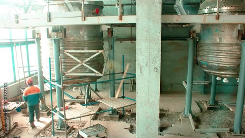 Timelapse of huge metal tanks checkup by professional workers in plant workshop during shift. Equipment of old chemical factory