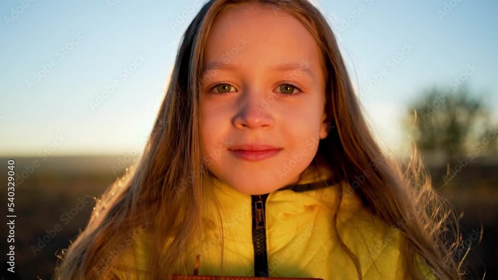 Close-up portrait of cute fair-haired girl. child looks into camera lens. One baby girl with blond hair looks forward into camera. Cute little girl face closeup Close-up portrait of cute fair-haired girl. child looks into camera lens. One baby girl with blond hair looks forward into camera. Cute little girl face closeup
