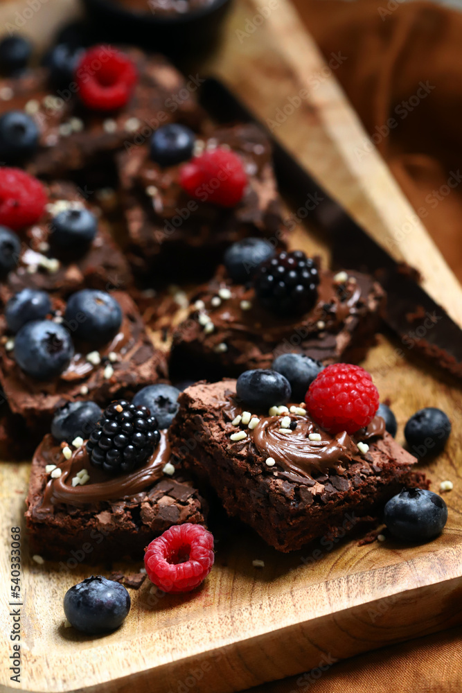 Macro. Brownie cakes with berries and chocolate on top. Delicious chocolate dessert. Macro. Brownie cakes with berries and chocolate on top. Delicious chocolate dessert.