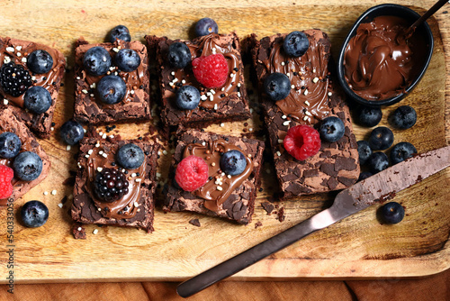 Macro. Brownie cakes with berries and chocolate on top. Delicious chocolate dessert.