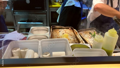 Professional Chef Takes Asparagus Off A Baking Tray In Commercial Kitchen