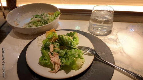 Mid Hand Held Shot Of Caesar Salad At A Restaurant