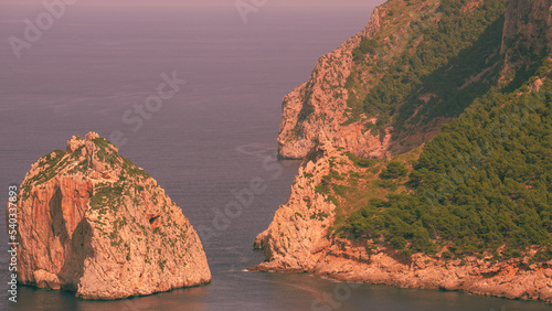 Rock formation in front of the rough Mallorcan coastline