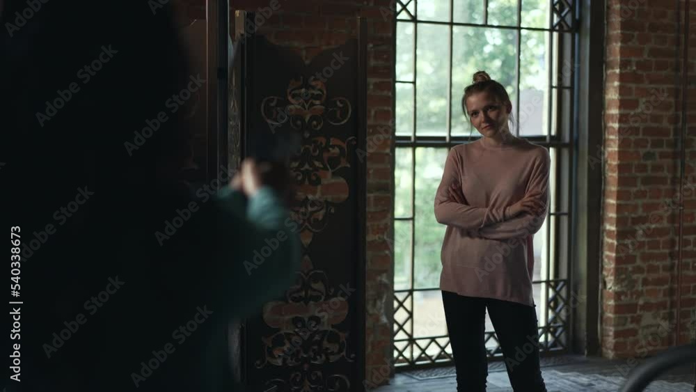 4k Young woman aims at another female and stands in room spbd. Killing eve concept.Asian woman is holding gun in hand and aiming at person, showing confusion and standing in retro interior. Two 4k Young woman aims at another female and stands in room spbd. Killing eve concept.Asian woman is holding gun in hand and aiming at person, showing confusion and standing in retro interior. Two