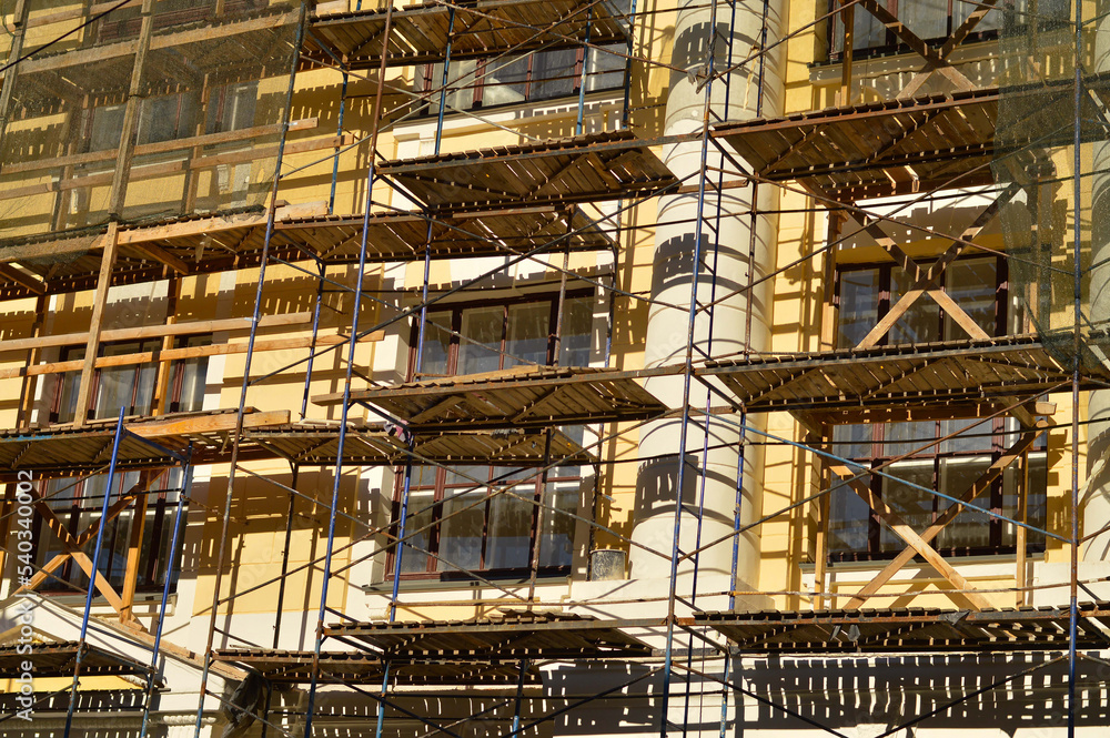 Metal scaffolding installed along the facade of building architecture for glazing facade and renew and renovation building