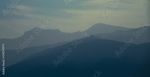 Silhouette of mountains in mist at dawn