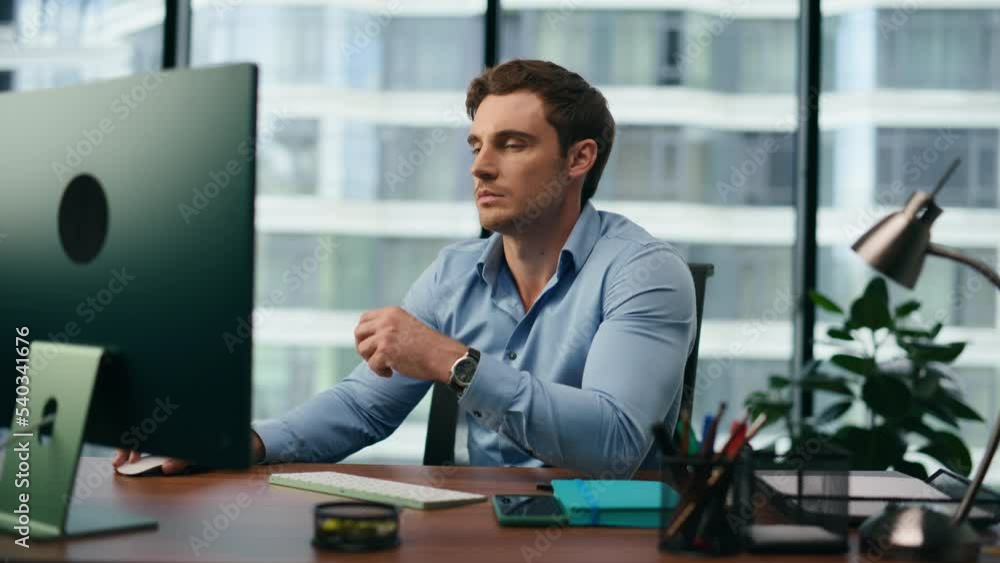 Office manager frustrated looking on computer monitor sitting at desk close up Office manager frustrated looking on computer monitor sitting at desk close up