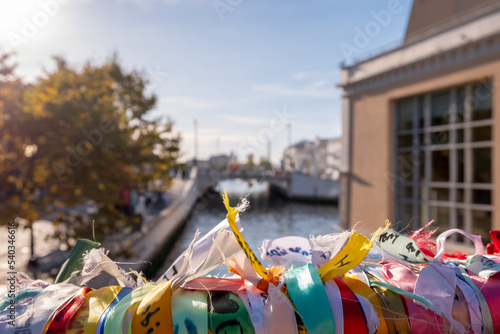Close up to the Ribbons in a bridge with love and friendship messages, and the Ria Canal of Aveiro and downtown center in the background. City of Aveiro, Portugal.