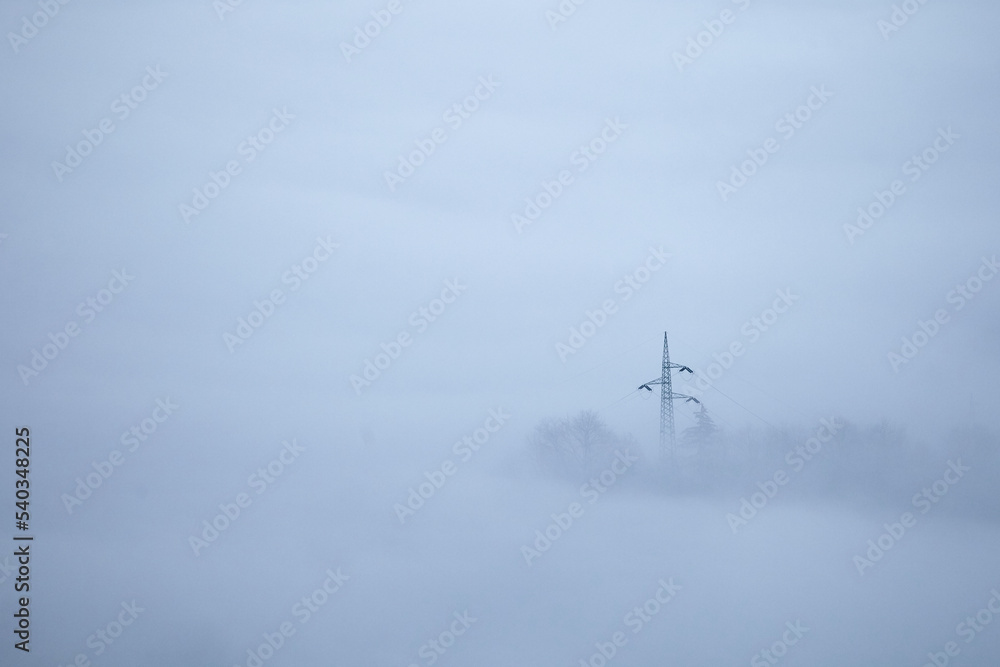Power line in mountain vallery with fog Power line in mountain vallery with fog