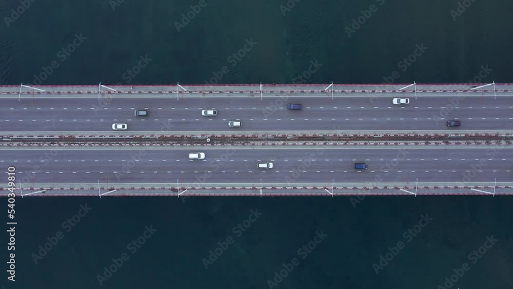 4k Above view of cars move on bridge over water outdoors irrl. Aerial of many vehicles driving on asphalt highway surrounded by blue waters in countryside in summer. Tourist captures modern 4k Above view of cars move on bridge over water outdoors irrl. Aerial of many vehicles driving on asphalt highway surrounded by blue waters in countryside in summer. Tourist captures modern