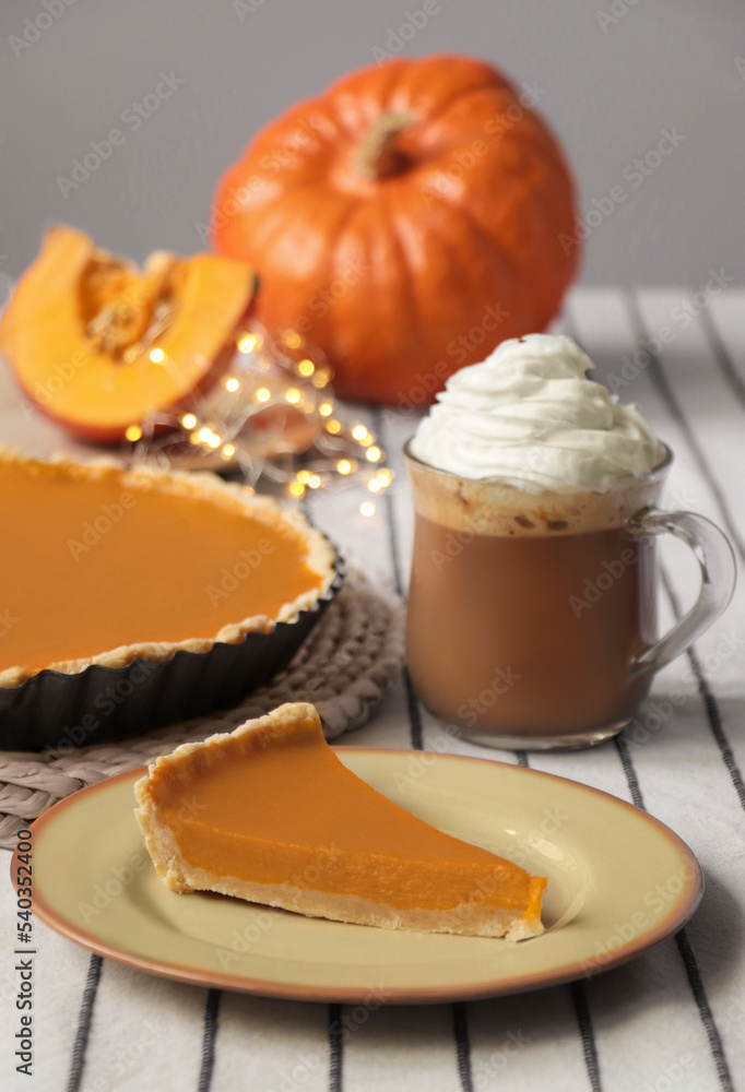 Fresh homemade pumpkin pie and cup of cocoa with whipped cream on table Fresh homemade pumpkin pie and cup of cocoa with whipped cream on table