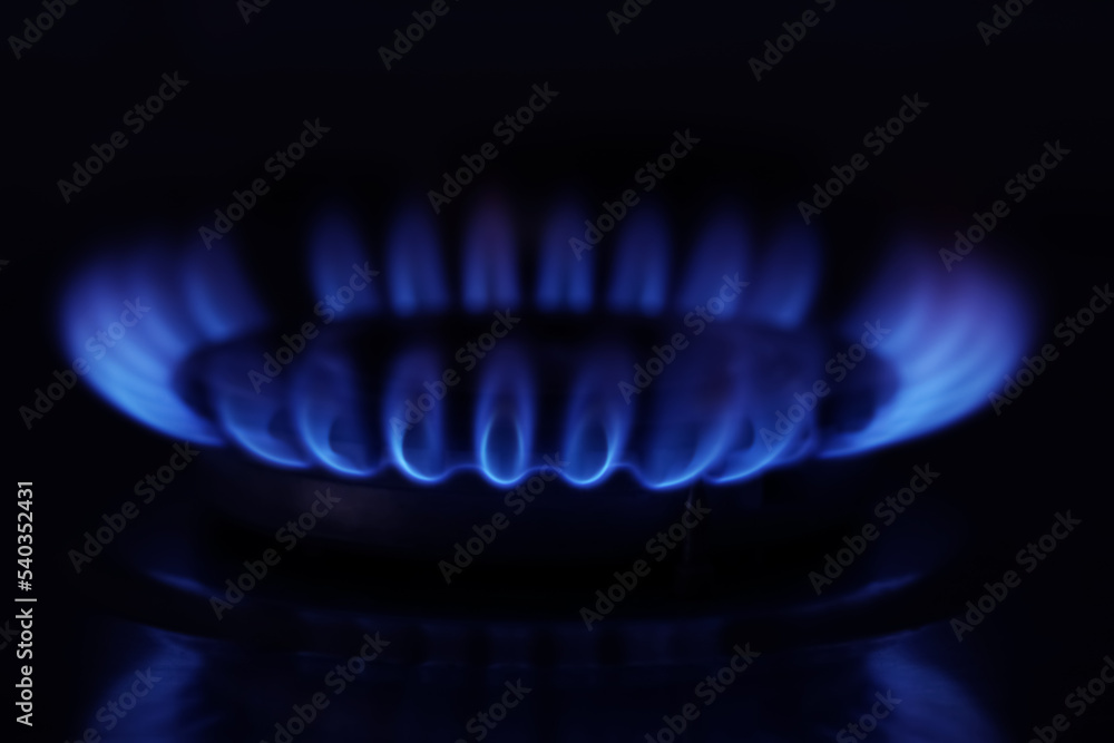 Gas burner with burning flame in darkness, closeup Gas burner with burning flame in darkness, closeup
