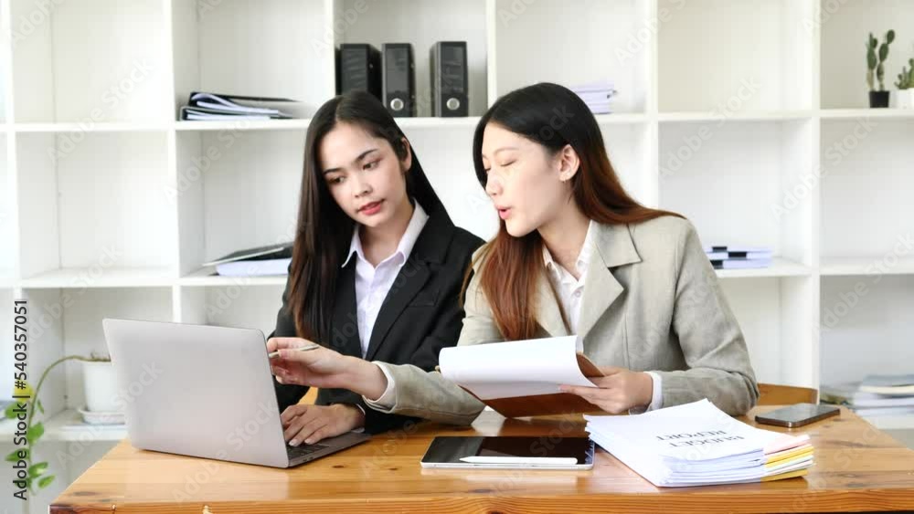 Asian woman working with customers in office Asian woman working with customers in office