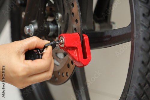 safety locks for motorcycles mounted on motorcycle brake discs.  anti theft lock on motorcycle photo