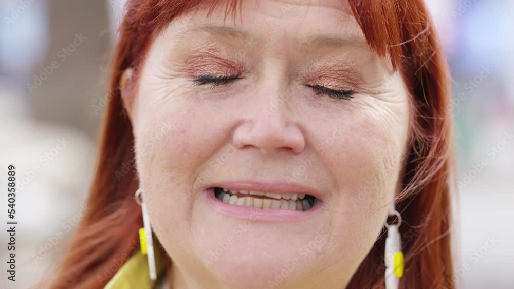 Close shot of mature female talking to camera Close shot of mature female talking to camera