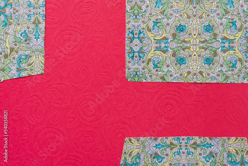 paper background featuring fancy envelope liners on red paper with old roses © eugen