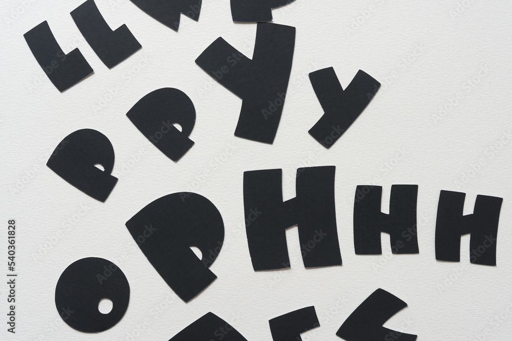 random black paper letters on blank paper random black paper letters on blank paper