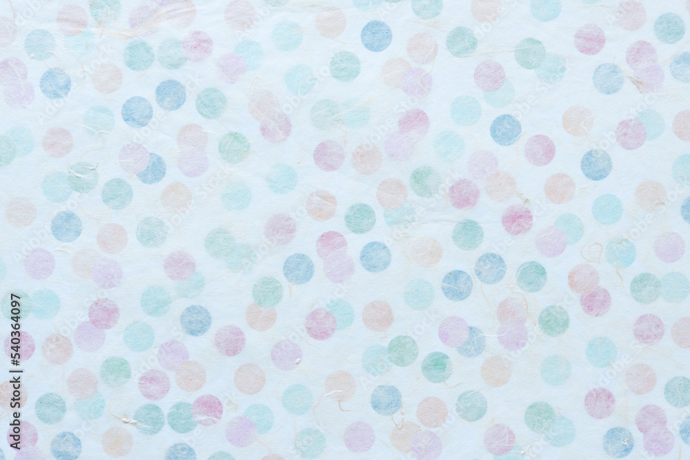 background with tissue paper and paper with colorful dots beneath