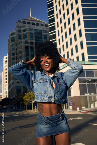 Portrait of young beautiful women with afro hair in the city photo