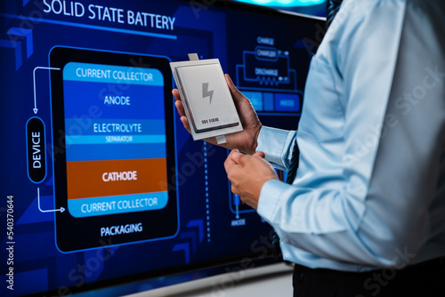 Engineer show solid state battery pack for electric vehicle (EV) on electronic screen, Battery technology that uses solid electrodes and a solid electrolyte.