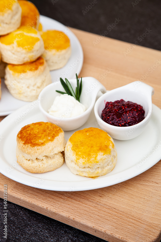 Homemade British Scones with clotted cream and raspberry jam Homemade British Scones with clotted cream and raspberry jam