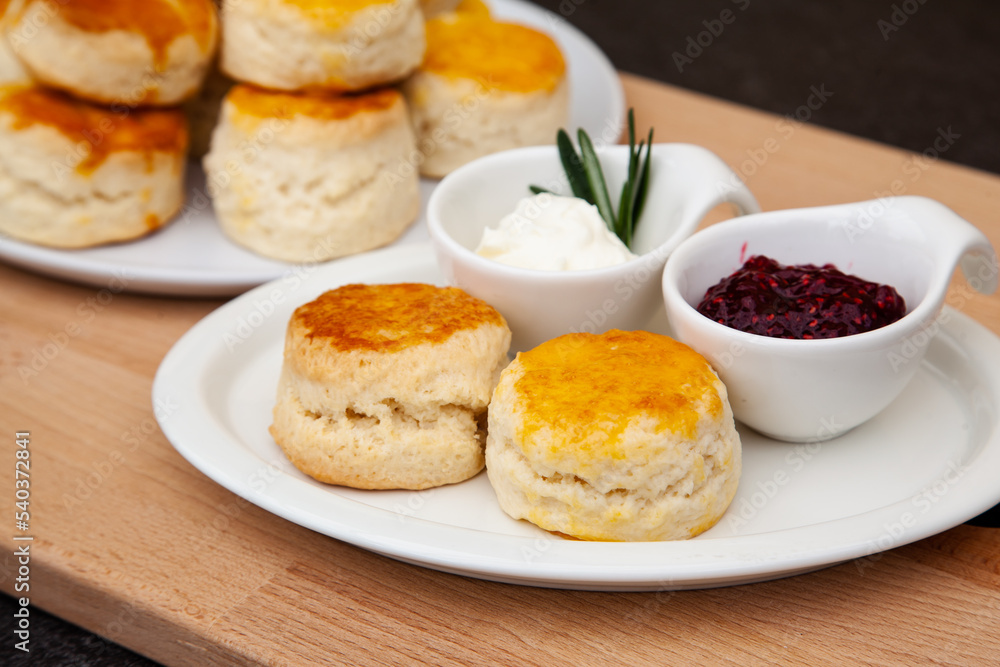 Homemade British Scones with clotted cream and raspberry jam Homemade British Scones with clotted cream and raspberry jam