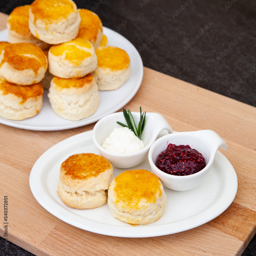 Homemade British Scones with clotted cream and raspberry jam Homemade British Scones with clotted cream and raspberry jam