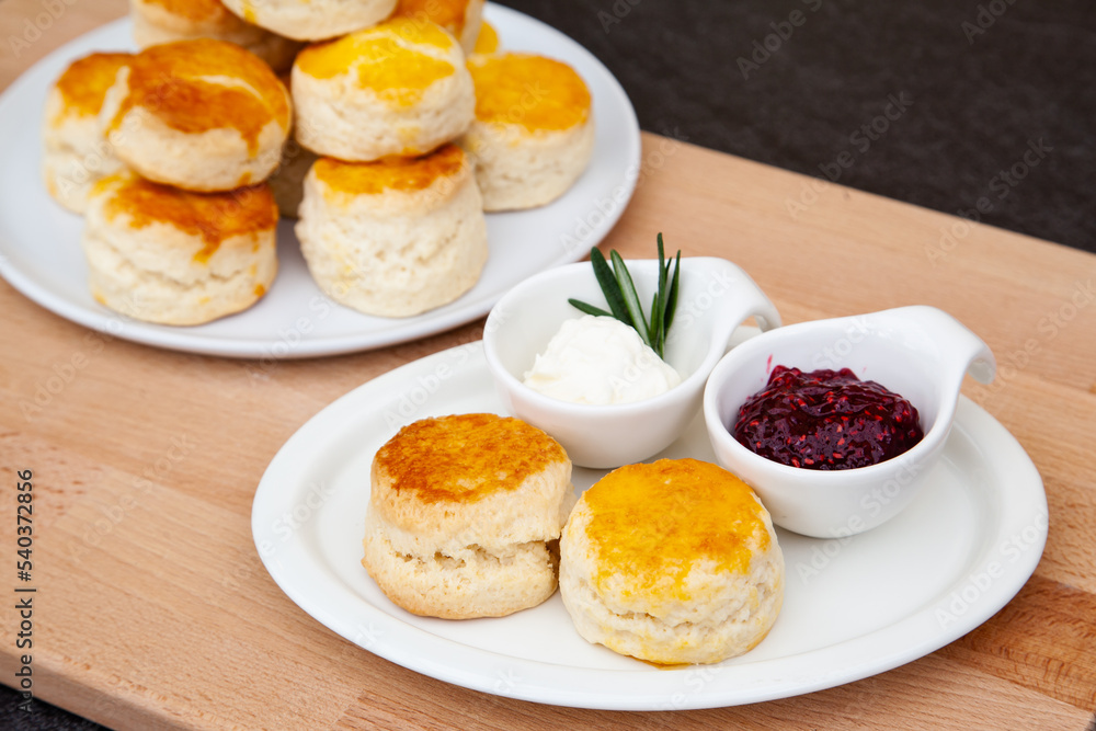 Homemade British Scones with clotted cream and raspberry jam Homemade British Scones with clotted cream and raspberry jam