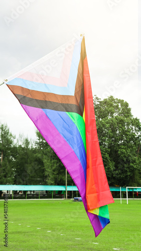 LGBT rainbow flag waving with blue sky in background to enhance LGBTQ  community around the world