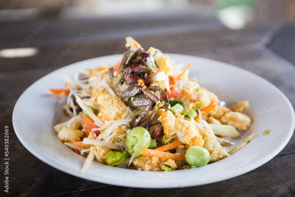 Som tum Thai is an incredibly popular Thai salad made of shredded green papaya. Som tum Thai is an incredibly popular Thai salad made of shredded green papaya.