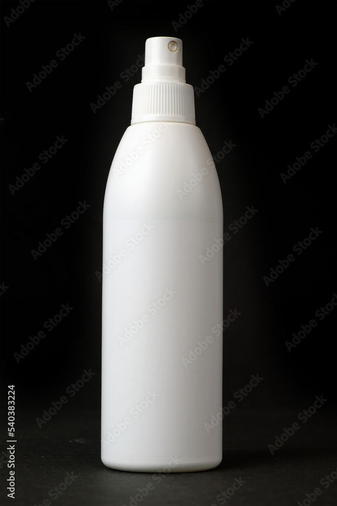Plastic aerosol spray white bottle on dark background Plastic aerosol spray white bottle on dark background