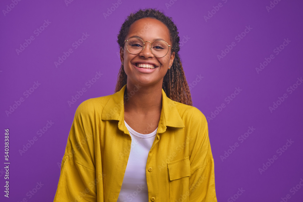 Φωτογραφία Young cute happy African American woman zoomer in casual clothes laughing and looking at camera radiating optimism and positive emotions stands on plain purple background