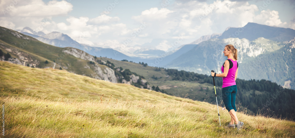 Fototapeta premium Young woman hiking in the mountains