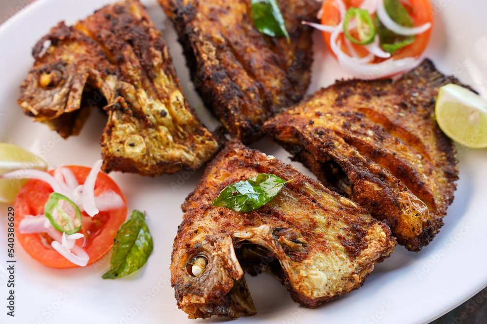 Kerala fish fry Karimeen Pollichathu a popular hot and spicy baked fish