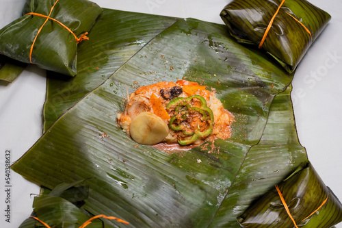 Top View of raw ingredients of the Nicaraguan nacatamal on banana leaves. Raw ingredients for the preparation of the traditional Nacatamal, Nacatamal ingredients on banana leaves photo