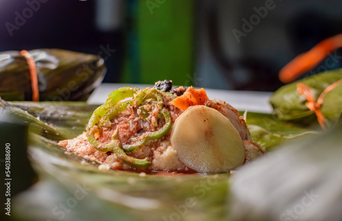Close-up of the raw ingredients of the Nicaraguan nacatamal on banana leaves. Raw ingredients for the preparation of the traditional Nacatamal, Nacatamal ingredients on banana leaves photo