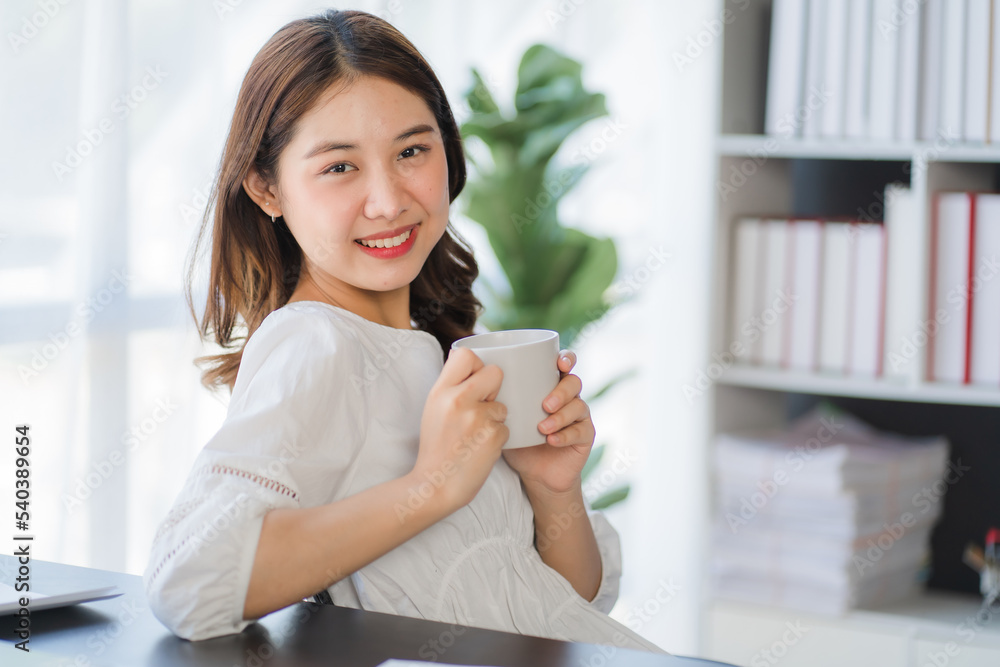 Asian Businesswoman Using laptop computer and working at office with calculator document on desk, doing planning analyzing the financial report, business plan investment, finance analysis concept. Asian Businesswoman Using laptop computer and working at office with calculator document on desk, doing planning analyzing the financial report, business plan investment, finance analysis concept.