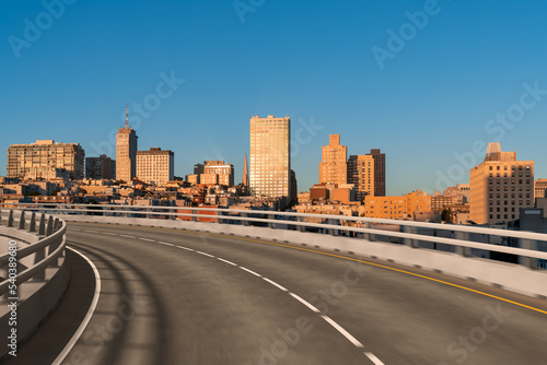 Empty urban asphalt road exterior with city buildings background. New modern highway concrete construction. Concept way to success. Transportation logistic industry fast delivery. San Francisco. USA.