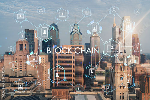 Aerial panoramic cityscape of Philadelphia financial downtown, Pennsylvania, USA. City Hall Clock Tower at sunrise. Decentralized economy. Blockchain, cryptocurrency and cryptography concept, hologram